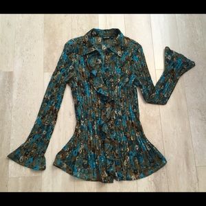 Stunning pleated blouse with flowing ruffles.